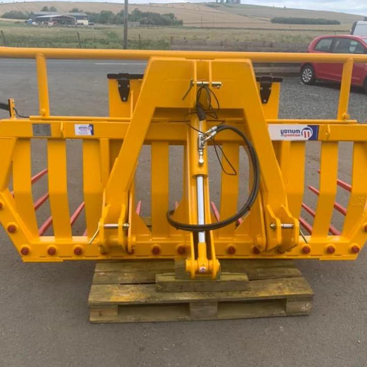 Hydraulic tipping stone fork with tool/weight box